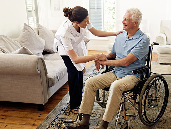 nurse taking care of the old man sitting in the chair